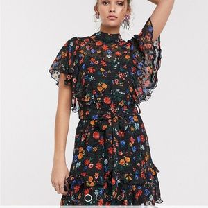 Black mock neck cap sleeve mini dress with tie detail